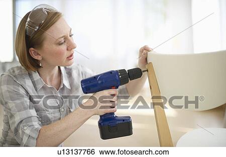 Woman repairing chair View Large Photo Image Stock Photograph - Woman repairing chair. Fotosearch