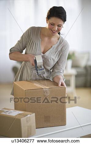 Woman taping cardboard boxes View Large Photo Image Stock Photo - Woman taping cardboard boxes. Fotosearch