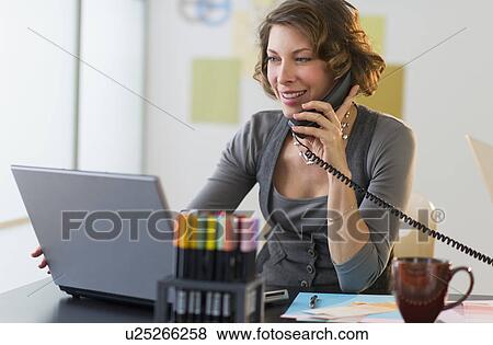 Woman working in home office View Large Photo Image Stock Photo - Woman working in home office. Fotosearch