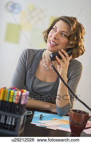 Stock Photograph - Woman working in home office. Fotosearch