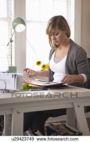 Stock Photo - Woman working in office. Fotosearch