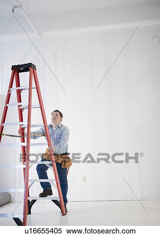 Worker climbing ladder View Large Photo Image Stock Photography - Worker climbing ladder. Fotosearch