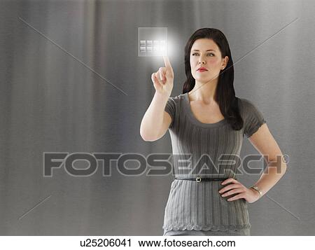 Young businesswoman using digital keypad View Large Photo Image Stock Image - Young businesswoman using digital keypad. Fotosearch