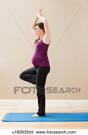 Young pregnant woman exercising, standing on one leg View Large Photo Image Stock Photography - Young pregnant woman exercising, standing on one leg. Fotosearch