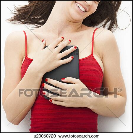 Young woman embracing electronic organizer View Large Photo Image Stock Image - Young woman embracing electronic organizer. Fotosearch