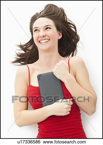Stock Photograph - Young woman embracing electronic organizer. Fotosearch