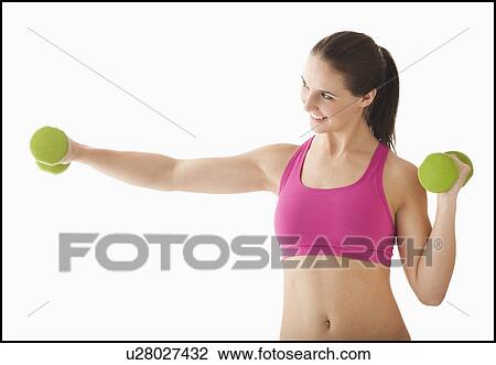 Young woman exercising with hand weights View Large Photo Image Stock Image - Young woman exercising with hand weights. Fotosearch