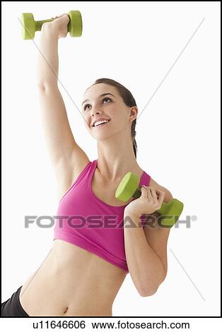 Young woman exercising with hand weights View Large Photo Image Stock Photograph - Young woman exercising with hand weights. Fotosearch