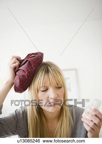 Young woman having headache View Large Photo Image Stock Photograph - Young woman having headache. Fotosearch