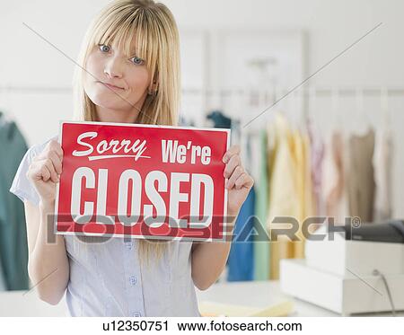 Young woman holding closed sign View Large Photo Image Stock Image - Young woman holding closed sign. Fotosearch