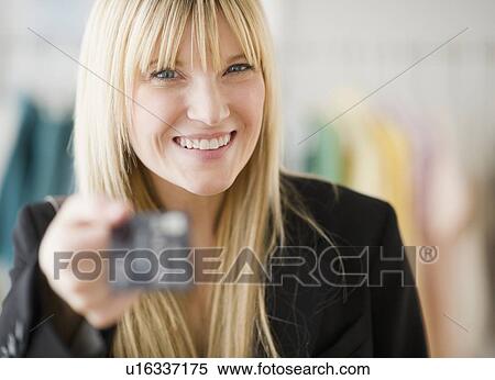 Young woman holding credit card View Large Photo Image Stock Photography - Young woman holding credit card. Fotosearch