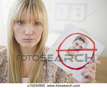 Young woman holding photograph of ex-boyfriend View Large Photo Image Stock Image - Young woman holding photograph of ex-boyfriend. Fotosearch