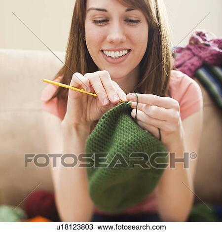 Young woman knitting woolly hat View Large Photo Image Stock Image - Young woman knitting woolly hat. Fotosearch