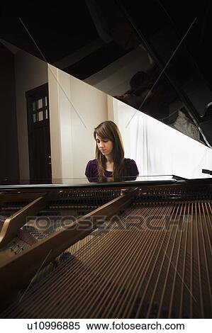 Young woman playing grand piano View Large Photo Image Stock Photography - Young woman playing grand piano. Fotosearch