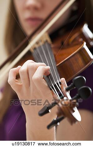 Young woman playing violin View Large Photo Image Stock Photo - Young woman playing violin. Fotosearch