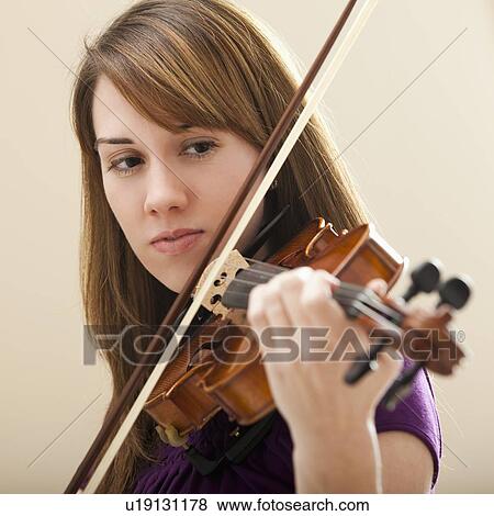Stock Photo - Young woman playing violin. Fotosearch