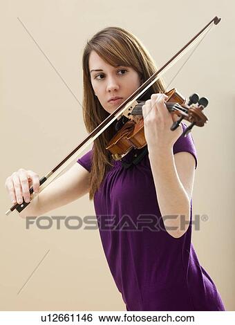 Young woman playing violin View Large Photo Image Stock Photograph - Young woman playing violin. Fotosearch
