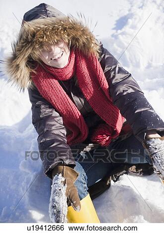 Young woman sitting on snow View Large Photo Image Stock Photograph - Young woman sitting on snow . Fotosearch