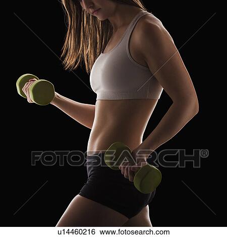 Young woman using hand weights View Large Photo Image Stock Photograph - Young woman using hand weights. Fotosearch