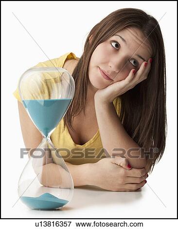 Young woman with hourglass View Large Photo Image Stock Photo - Young woman with hourglass. Fotosearch