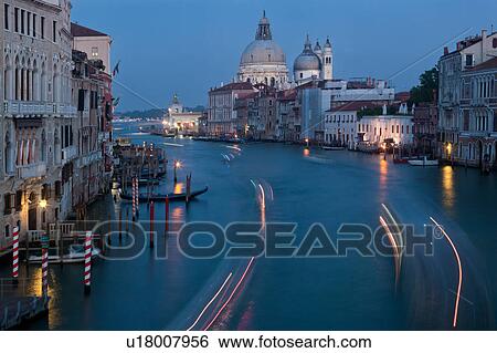 Aerial view of Grand Canal, looking towards church of Santa Maria della Salute, multicoloured lines from motion blur of boat lights at twilight, looking beyond to San Marco Basin, Venice, Northern Italy View Large Photo Image Stock Photograph - Aerial view of Grand Canal, looking towards church of Santa Maria della Salute, multicoloured lines from motion blur of boat lights at twilight, looking beyond to San Marco Basin, Venice, Northern Italy. Fotosearch