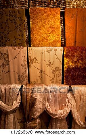 Brown, orange, and cream velvet and silk scarves, hanging in four rows, window display, Venice, Northern Italy View Large Photo Image Stock Image - Brown, orange, and cream velvet and silk scarves, hanging in four rows, window display, Venice, Northern Italy. Fotosearch