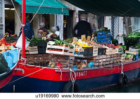 Close up of fruit and vegetable market on colourful blue and red barge with motion blur of vendor and shoppers, sunny autumn morning in Venice, Northern Italy View Large Photo Image Stock Image - Close up of fruit and vegetable market on colourful blue and red barge with motion blur of vendor and shoppers, sunny autumn morning in Venice, Northern Italy. Fotosearch