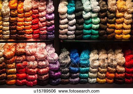 Stock Photograph - Multicoloured silk scarves twisted in window display, Venice, Northern Italy. Fotosearch