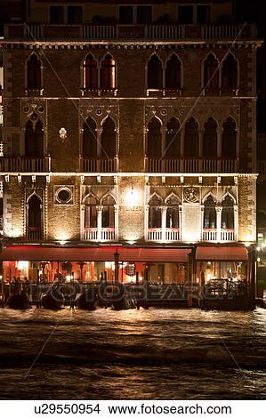 Night view of Grand Canal with Palazzo illuminated at dusk, moored gondolas in front of canal -side restaurants, autumn in Venice, Northern Italy View Large Photo Image Picture - Night view of Grand Canal with Palazzo illuminated at dusk, moored gondolas in front of canal -side restaurants, autumn in Venice, Northern Italy. Fotosearch