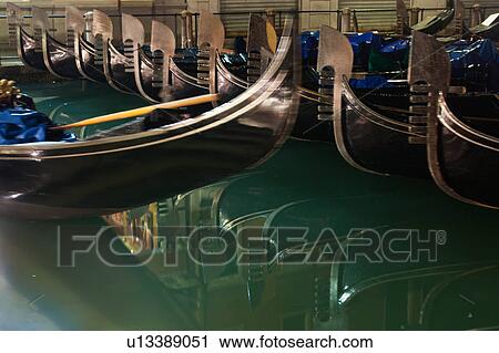 Parked gondolas parked in rows, reflected in water at night, close up view, Venice, Northern Italy View Large Photo Image Stock Image - Parked gondolas parked in rows, reflected in water at night, close up view, Venice, Northern Italy. Fotosearch
