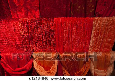 Red velvet and silk scarves hanging in four rows, window display, Venice, Northern Italy View Large Photo Image Stock Photograph - Red velvet and silk scarves hanging in four rows, window display, Venice, Northern Italy. Fotosearch