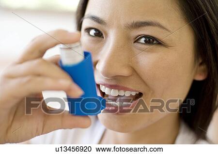 Stock Image - Asthma inhaler use. Fotosearch