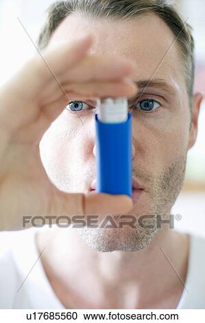 Stock Image - Asthma inhaler use. Fotosearch