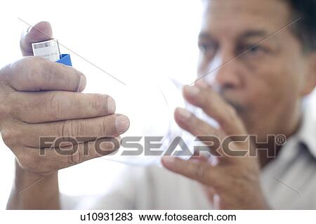 Stock Image - Asthma spacer use. Fotosearch