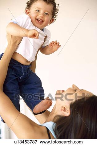 Stock Photo - Baby boy and mother. Fotosearch