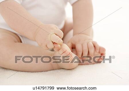 Stock Photo - Baby's hands and feet. Fotosearch