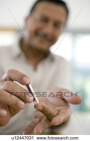 Stock Image - Blood glucose test. Fotosearch