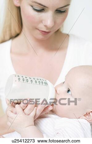 Bottle feeding View Large Photo Image Stock Image - Bottle feeding. Fotosearch