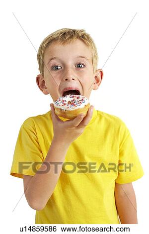 Stock Photograph - Boy eating a doughnut. Fotosearch