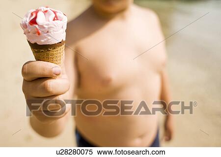 Boy holding an ice cream View Large Photo Image Stock Photography - Boy holding an ice cream. Fotosearch