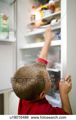 Boy looking in fridge View Large Photo Image Stock Photograph - Boy looking in fridge. Fotosearch
