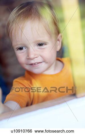 Stock Photograph - Boy playing in a Wendy house. Fotosearch