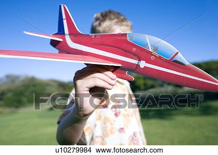 Boy playing with a model aeroplane View Large Photo Image Picture - Boy playing with a model aeroplane. Fotosearch