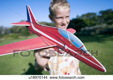 Picture - Boy playing with a model aeroplane. Fotosearch