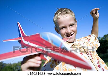 Stock Photo - Boy playing with a model aeroplane. Fotosearch