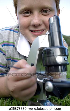 Boy using a light microscope View Large Photo Image Stock Image - Boy using a light microscope. Fotosearch