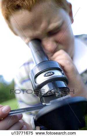 Boy using a light microscope View Large Photo Image Stock Photography - Boy using a light microscope. Fotosearch