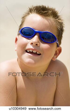 Stock Photo - Boy wearing sunglasses. Fotosearch