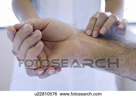 Stock Photograph - Checking pulse. Fotosearch