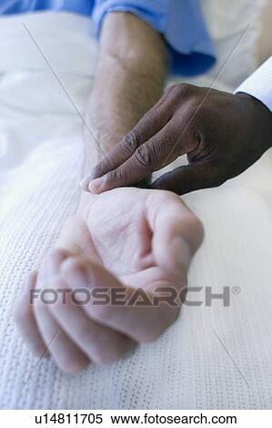 Stock Photography - Checking pulse. Fotosearch